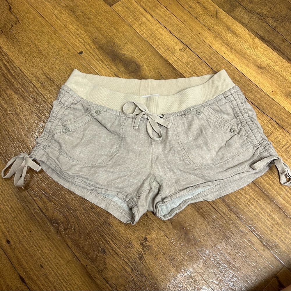 Tan shorts with bows on the sides and adjustable waist